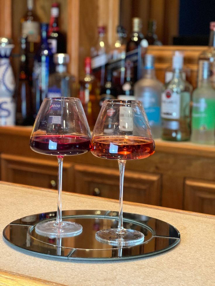 two wine glasses sitting on top of a counter