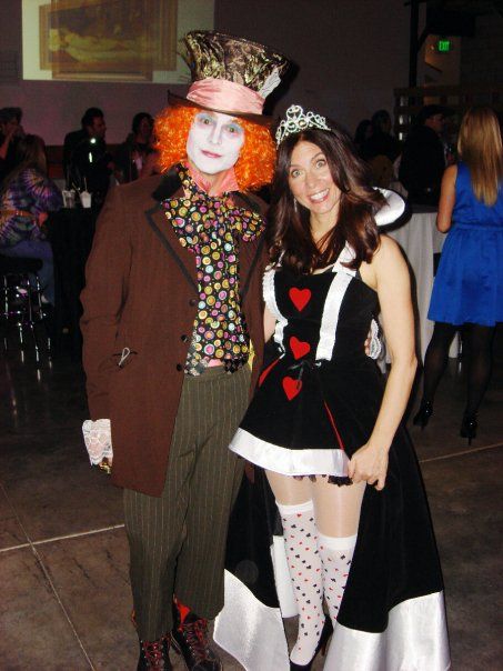 two people dressed up as clowns at a party