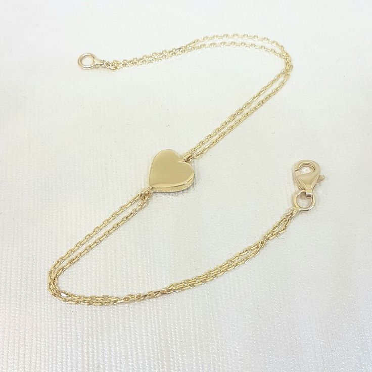 -The heart bracelet is made with high quality 14K real solid gold. The size of the heart is 8mm X 8mm. There is double chain. - This tiny, dainty, charm, delicate and trendy bracelet has been artfully designed for timeless yet modern millennial fashion. - You receive the bracelet in a beautiful and free gift box. - The bracelet length is 7 inches. We can shorten it. just write on personelized ares. - Free shipping (Arrive within 4 business days to USA and Canada ( 1 day for production + 3 days f Heart-shaped Yellow Gold Formal Bracelets, Heart-shaped Yellow Gold Bracelets For Formal Occasions, Classic Heart Jubilee Bracelet For Valentine's Day, Formal Heart-shaped Yellow Gold Bracelets, Formal Yellow Gold Heart Bracelets, Classic Heart-shaped Chain Bracelet As Gift, Classic Heart Shaped Chain Bracelet As Gift, Classic Heart-shaped Chain Bracelet Gift, Classic Heart Pendant Bracelet As Gift