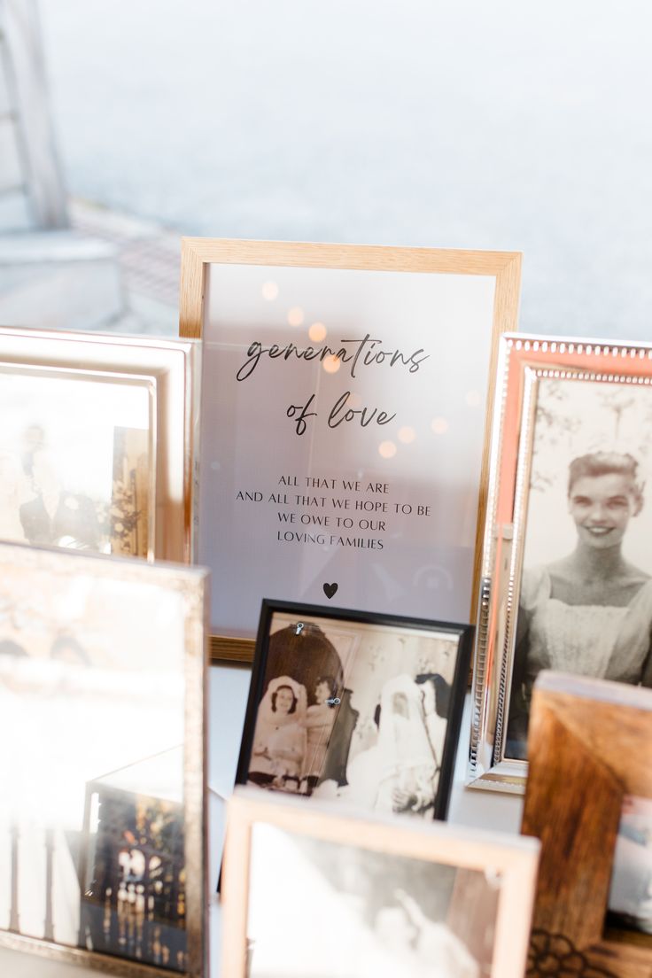 a table topped with pictures and framed photos next to a sign that says generations of love