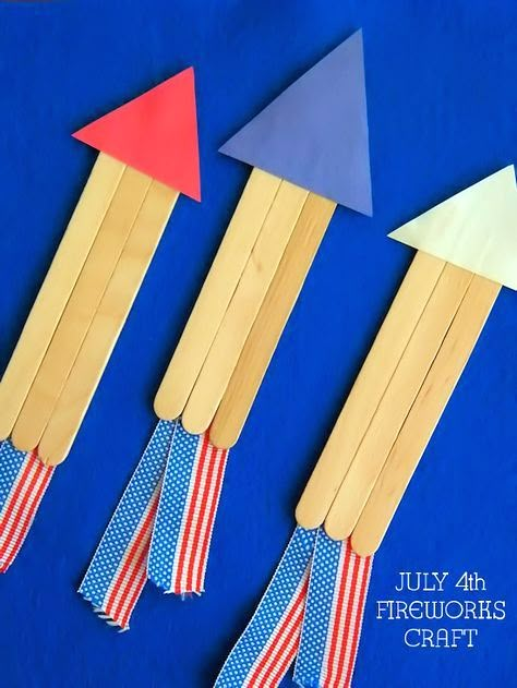 three popsicle sticks with red, white and blue paper on them sitting next to each other