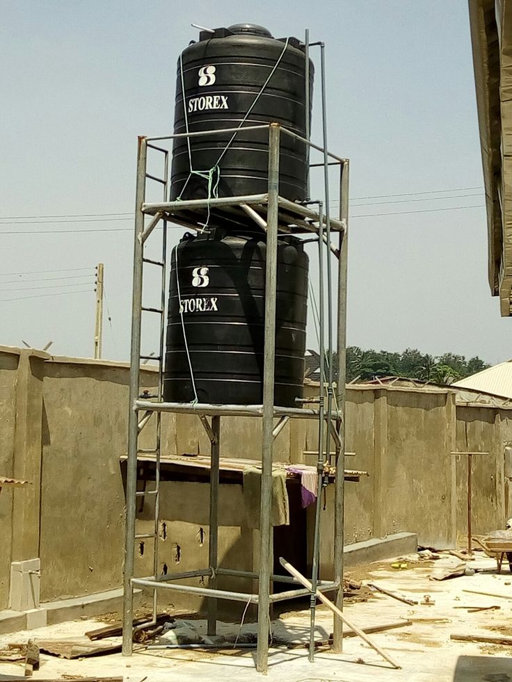 two large black tanks sitting on top of a building