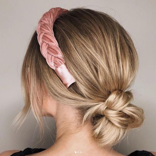 Give yourself two extra minutes in the morning to throw this low bun together. Pick a pretty headband to cap off the look. #hairstyles #updos #southernliving Low Bun Headband Hairstyles, Low Bun Headband, Short Hair Updo With Headband, Easy Updo With Headband, Headband Bun Hairstyles, Wedding Headband Hairstyles, Hairstyles With Headbands Hair Up, Low Bun With Headband, Bun And Headband