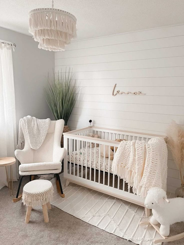 a baby's room with a crib, rocking chair and rugs on the floor