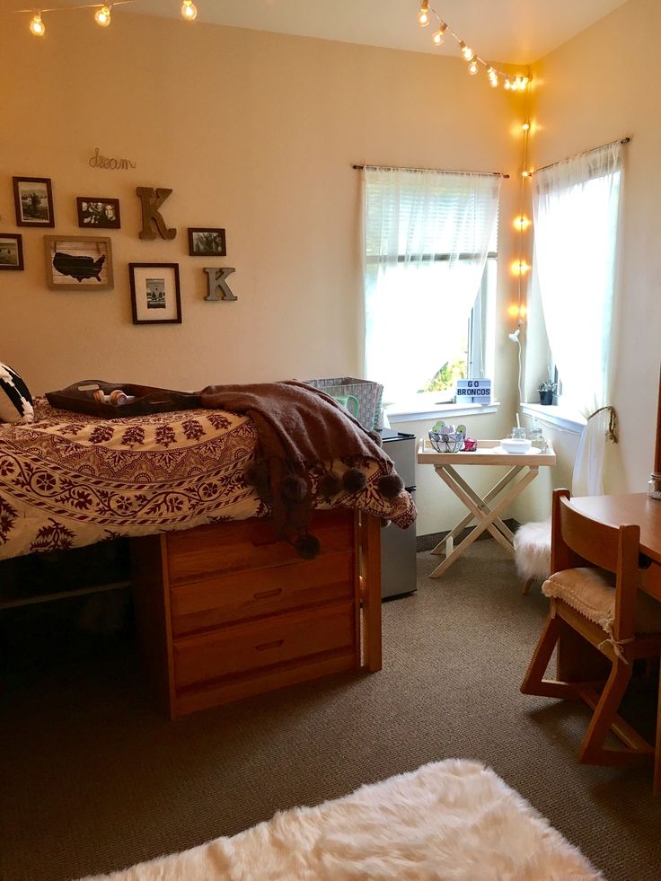 a bedroom with lights strung from the ceiling