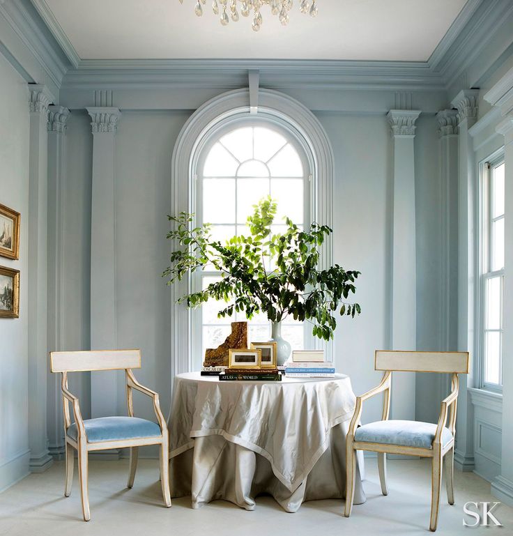 a table with two chairs and a potted plant