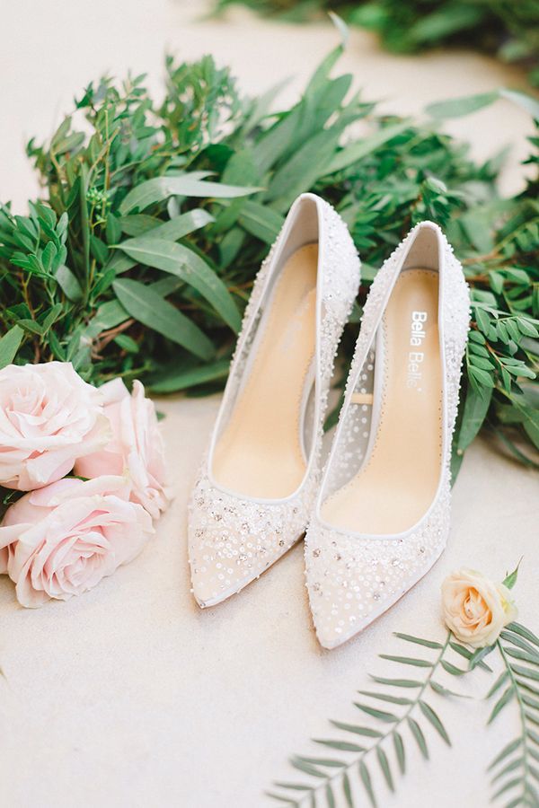 wedding shoes and flowers on the ground