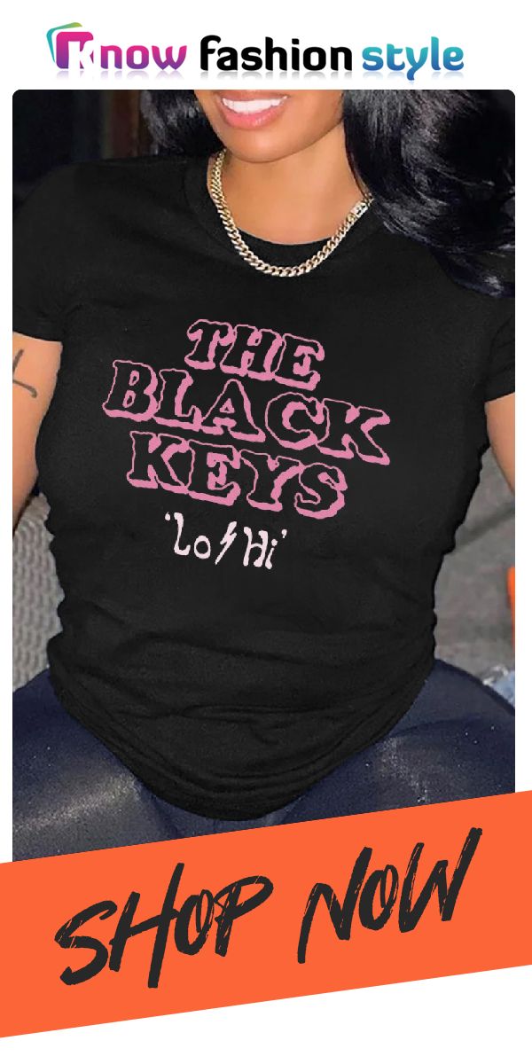 a woman wearing a black shirt with pink lettering on it