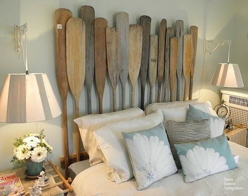 a bed with wooden paddles mounted to it's headboard