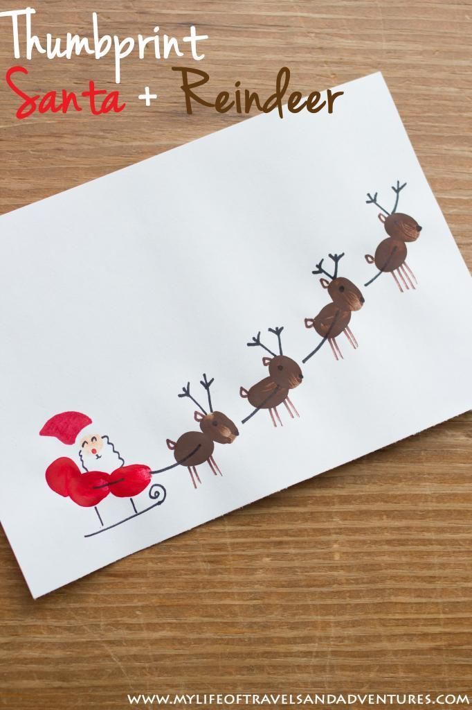 a handprinted santa reindeer is on top of a sheet of paper