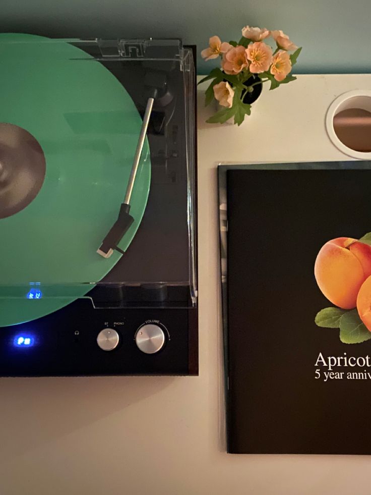 two cd's sitting next to each other on top of a table with flowers