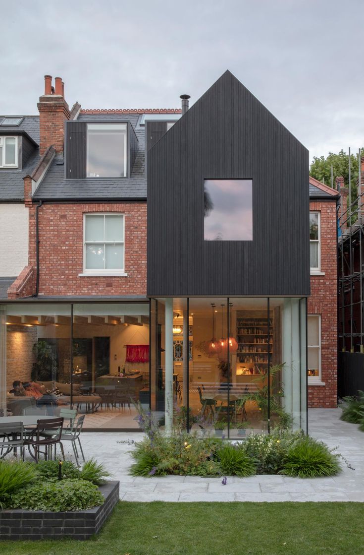 the house is surrounded by grass and plants