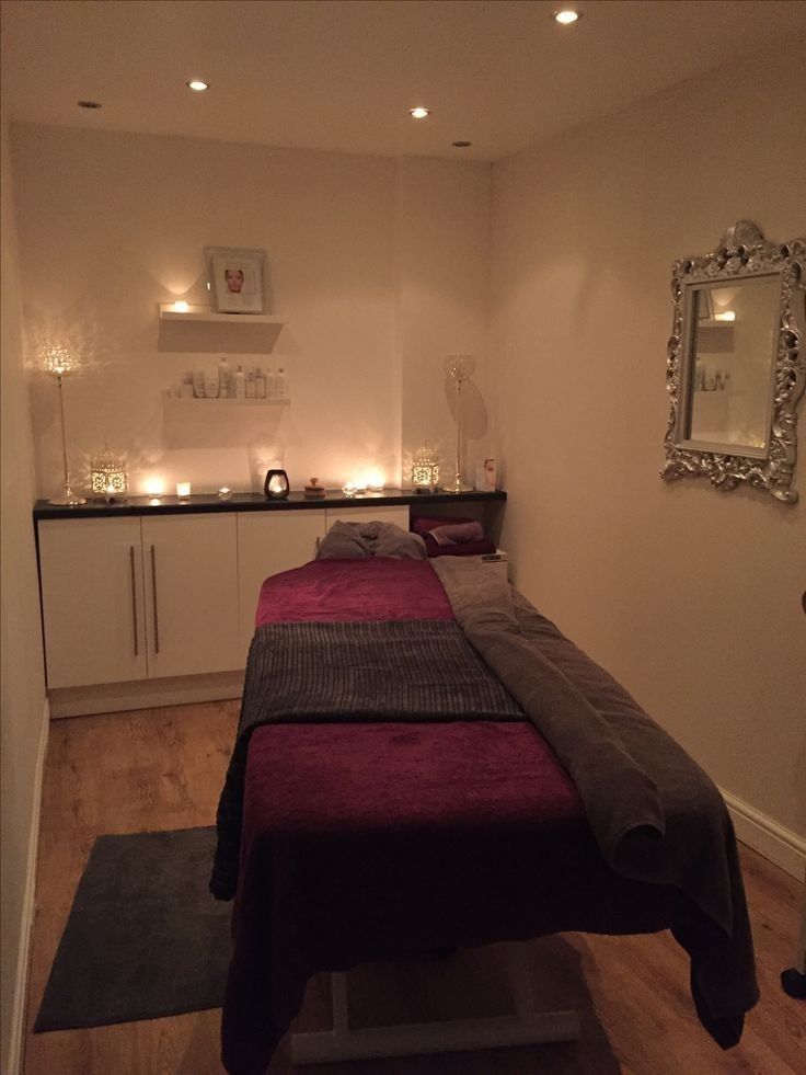 a massage room with lights on the wall