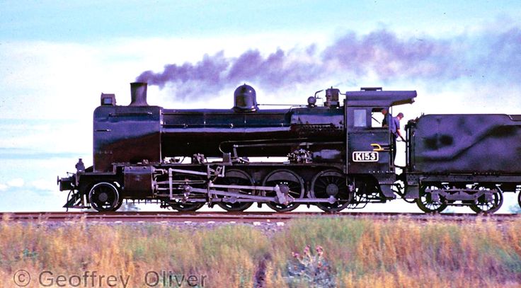 an old fashioned steam train traveling down the tracks