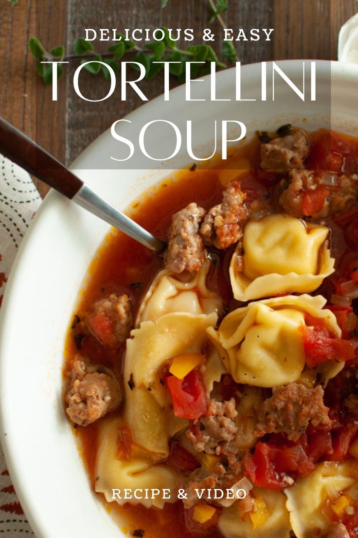 tortellini soup with meat and vegetables in a white bowl