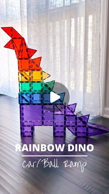 the rainbow dino car is made out of plastic blocks