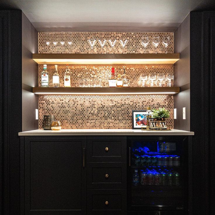 a bar with bottles on the shelves and lights above it, along with other items