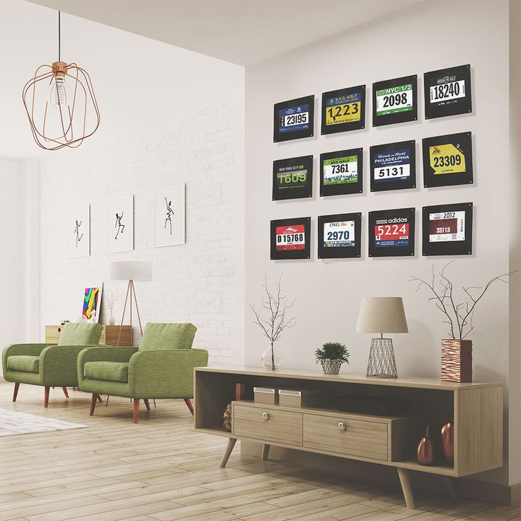 a living room filled with furniture and pictures hanging on the wall above a coffee table