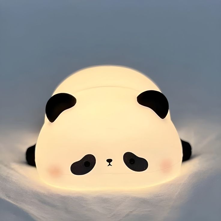 a panda bear lamp sitting in the snow