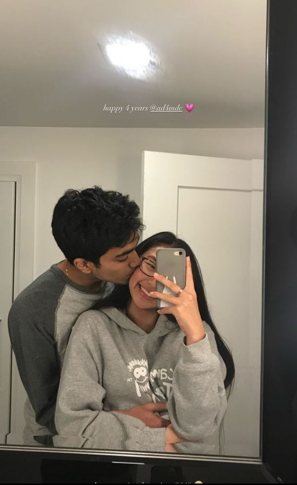 a man and woman taking a selfie in front of a mirror with the words happy valentine's day written on it