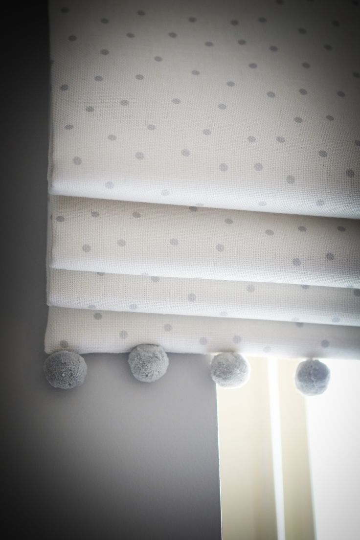 a window with white and gray polka dots on it