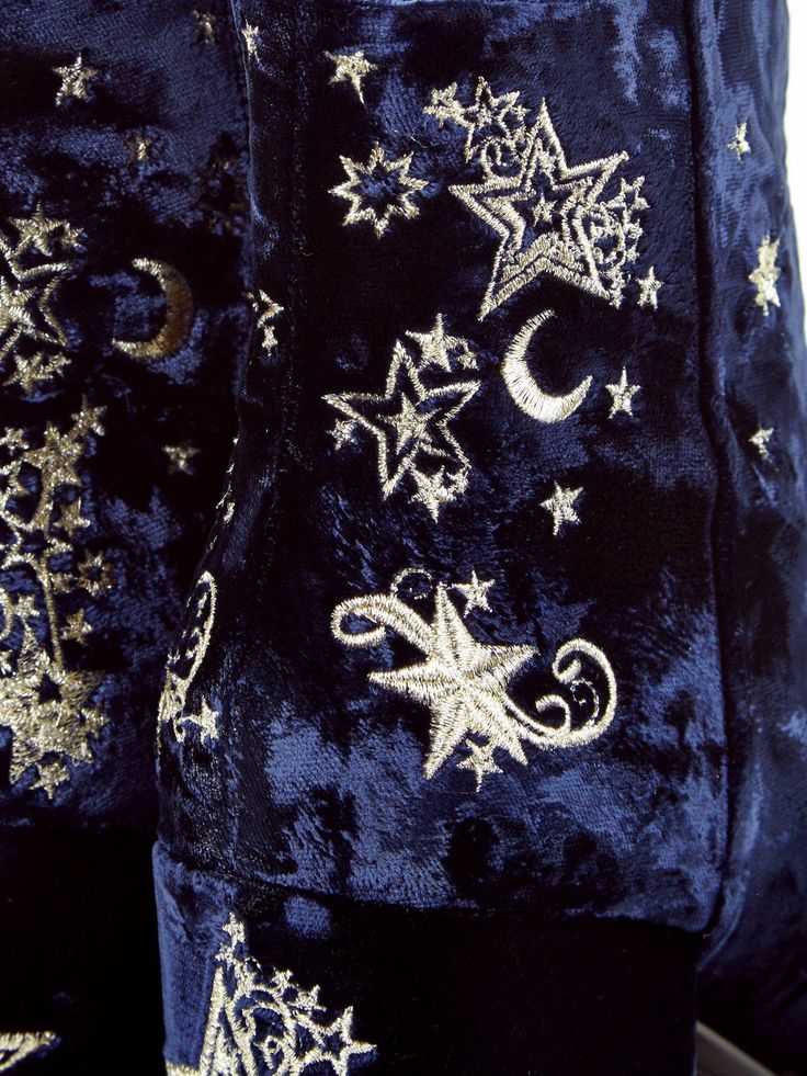 two blue and gold velvet bags with stars, moon and crescent designs on the side