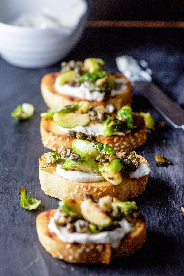 three pieces of bread topped with broccoli and other toppings