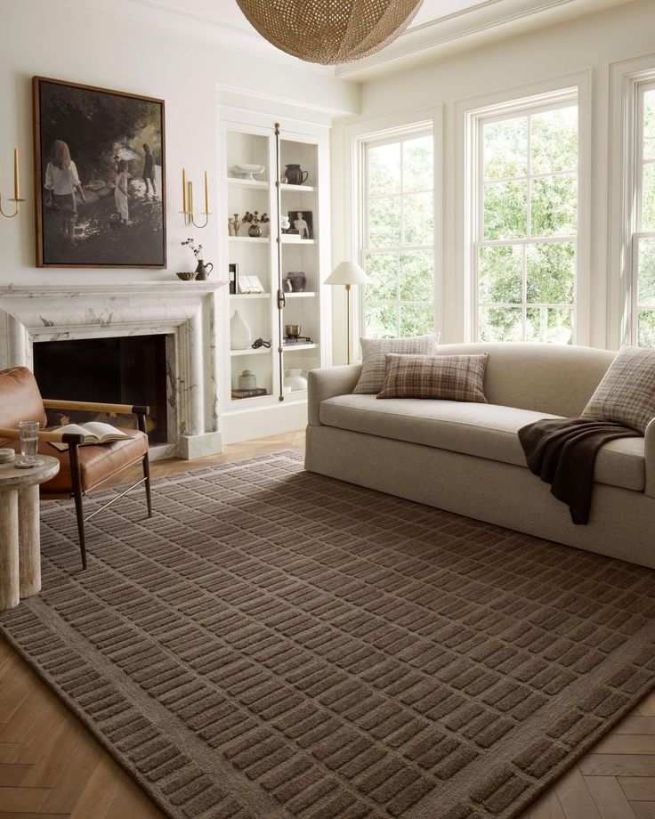 a living room filled with furniture and a fire place