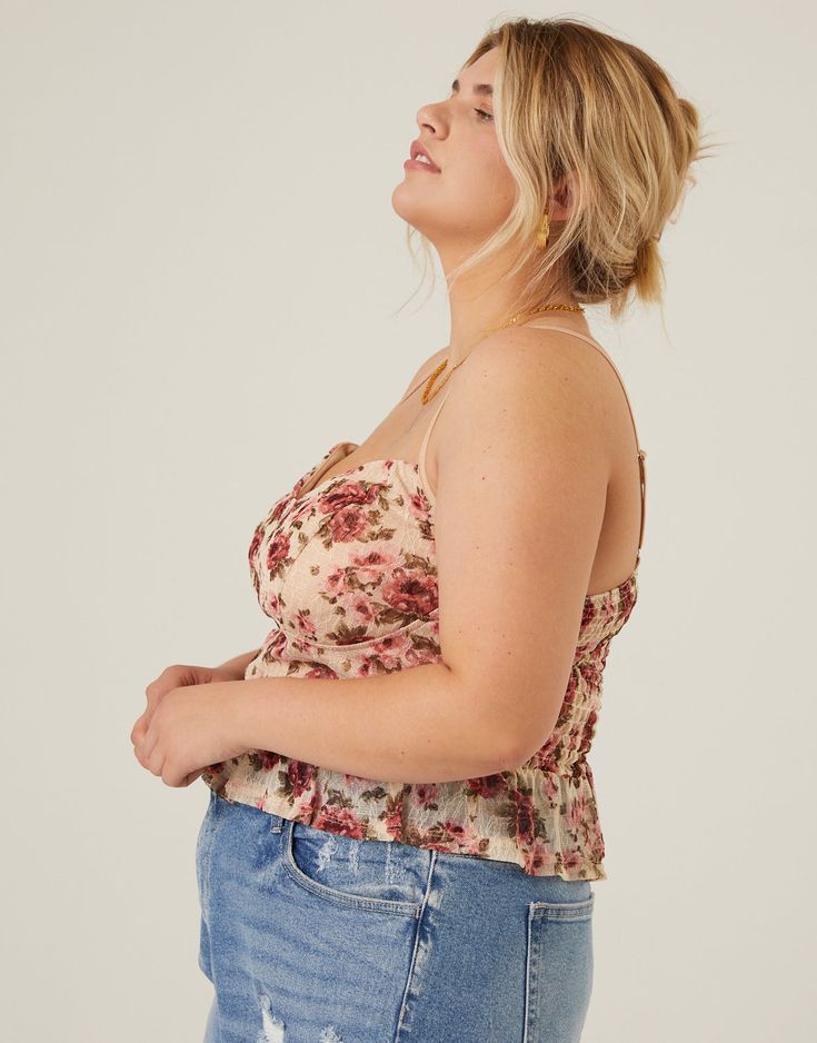 An adorable cropped tank with character, the Curve Floral Bustier Cropped Tank is a piece that begs to be turned into an outfit. This adorable top features structured bust seaming, adjustable spaghetti straps, a ruffled bottom section, and a smocked upper back. The material is a stretchy, sheer mesh fabric and the bust is lined. This top is made from 90% polyester and 10% spandex, and the lining is 100% polyester. Machine wash cold. Imported. Model is wearing a size 1XL. 1XL 2XL 3XL Bust (in) 34 Fitted Tops With Smocked Bodice And Spaghetti Straps, Casual Tops With Delicate Straps And Structured Fit, Spring Cropped Crop Top With Delicate Straps, Spring Crop Top With Medium Bust Support, Fitted Cropped Tank Top With Delicate Straps, Fitted Camisole Top With Smocked Bodice, Spring Cropped Top With Delicate Straps, Spring Cropped Camisole With Adjustable Straps, Spring Cami Top With Medium Bust Support