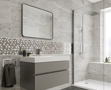 a bathroom with grey tiles and white fixtures