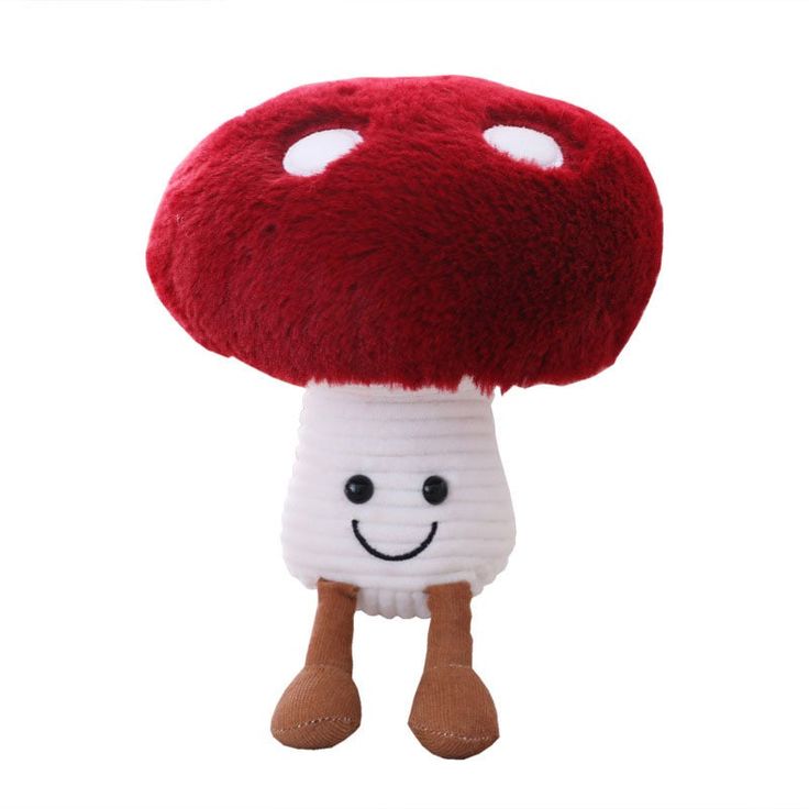 a stuffed mushroom with a smile on it's face is shown in front of a white background