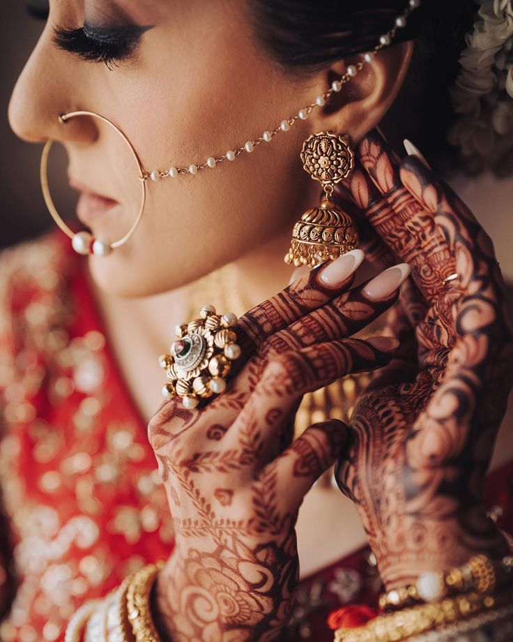 a woman with henna and jewelry on her hands