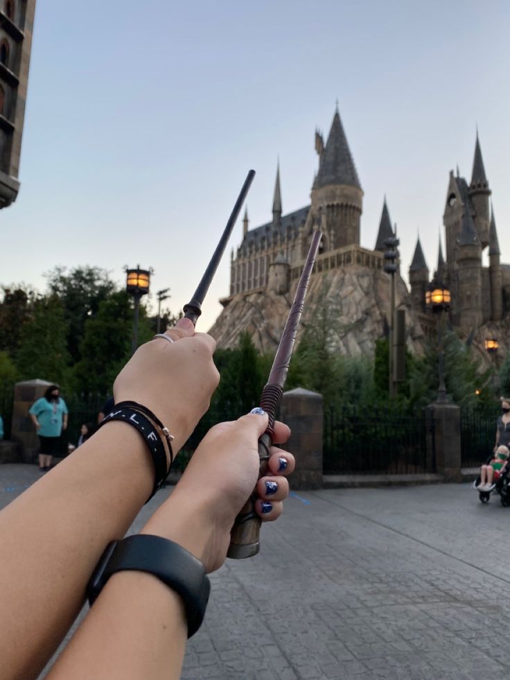 a person holding a knife in front of a castle