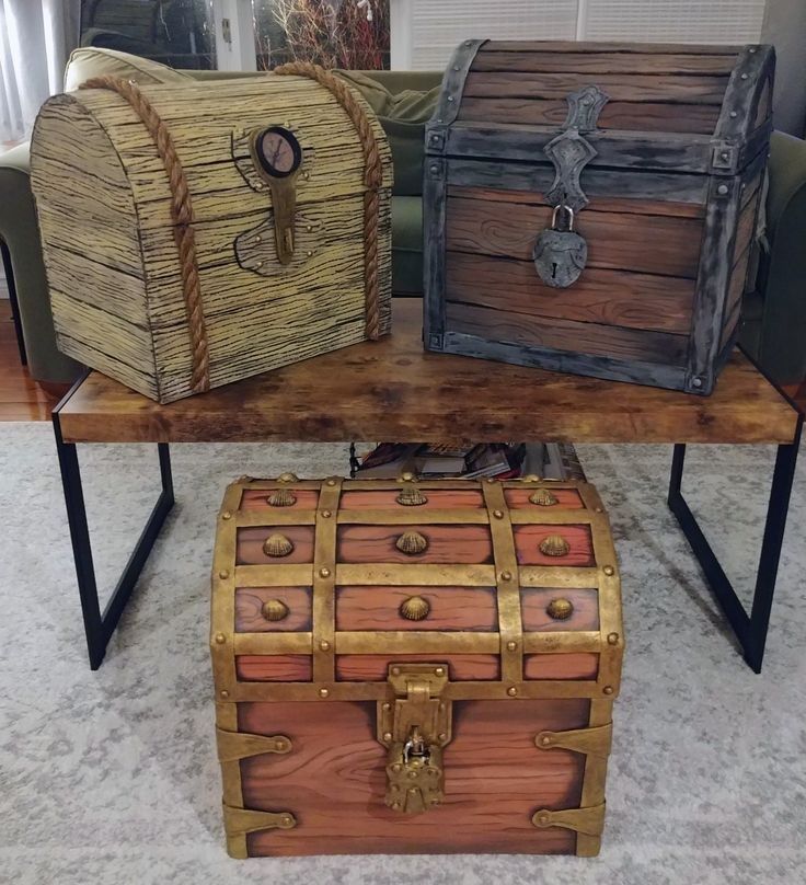 three wooden chests sitting on top of a table