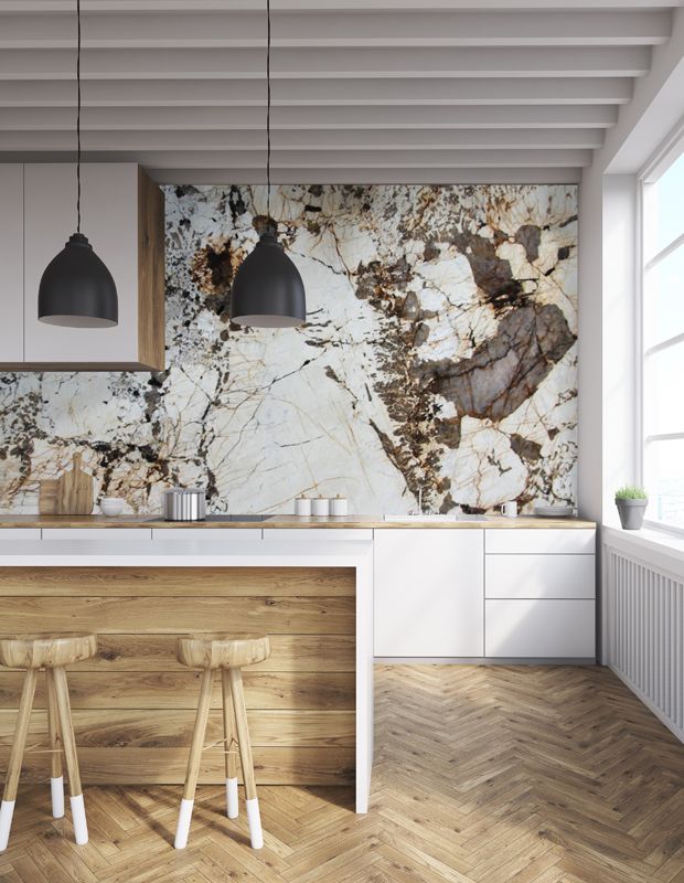 a kitchen with marble counter tops and wooden stools