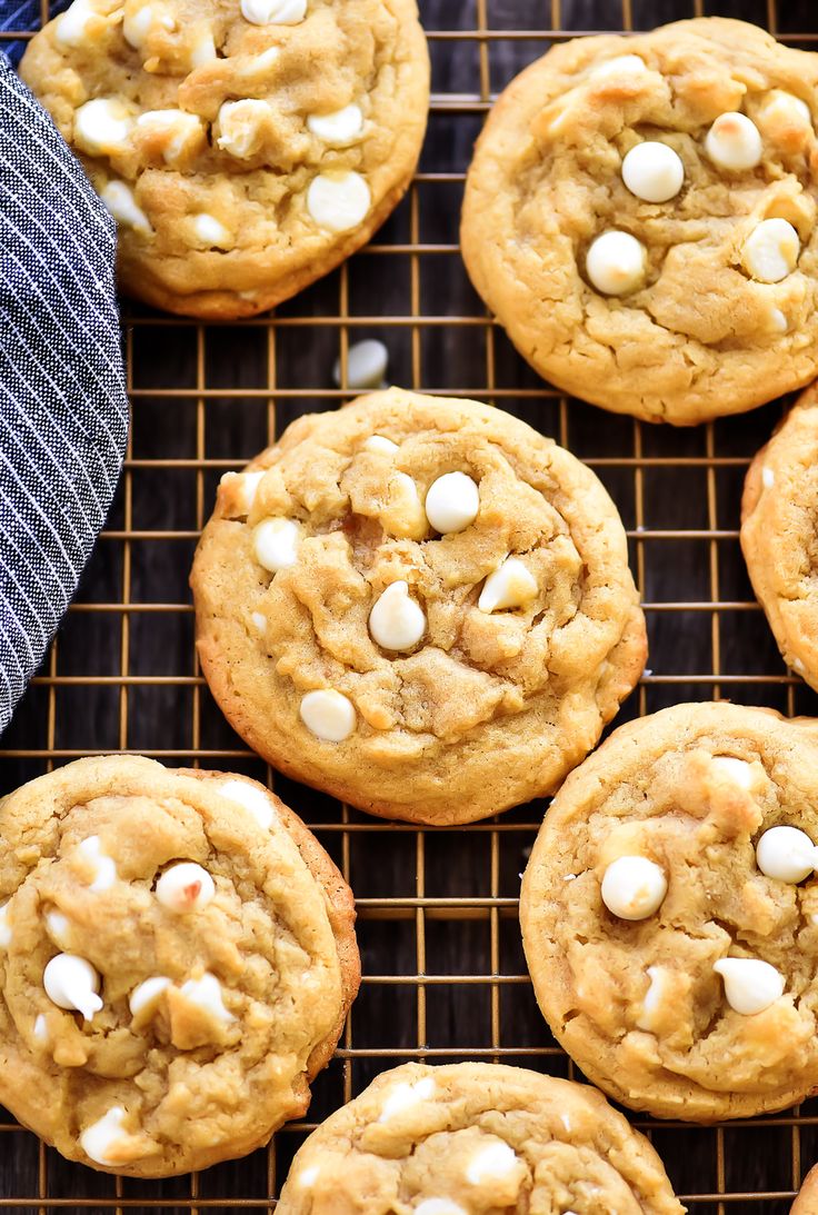 several cookies with white chocolate chips on a cooling rack