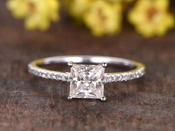 a princess cut diamond ring with pave set shoulders