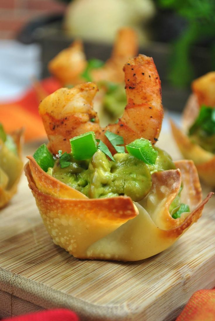 shrimp and guacamole cups on a cutting board