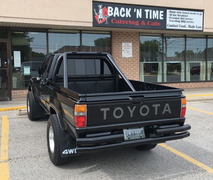 a black truck parked in front of a building