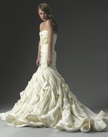 a woman in a wedding dress posing for the camera