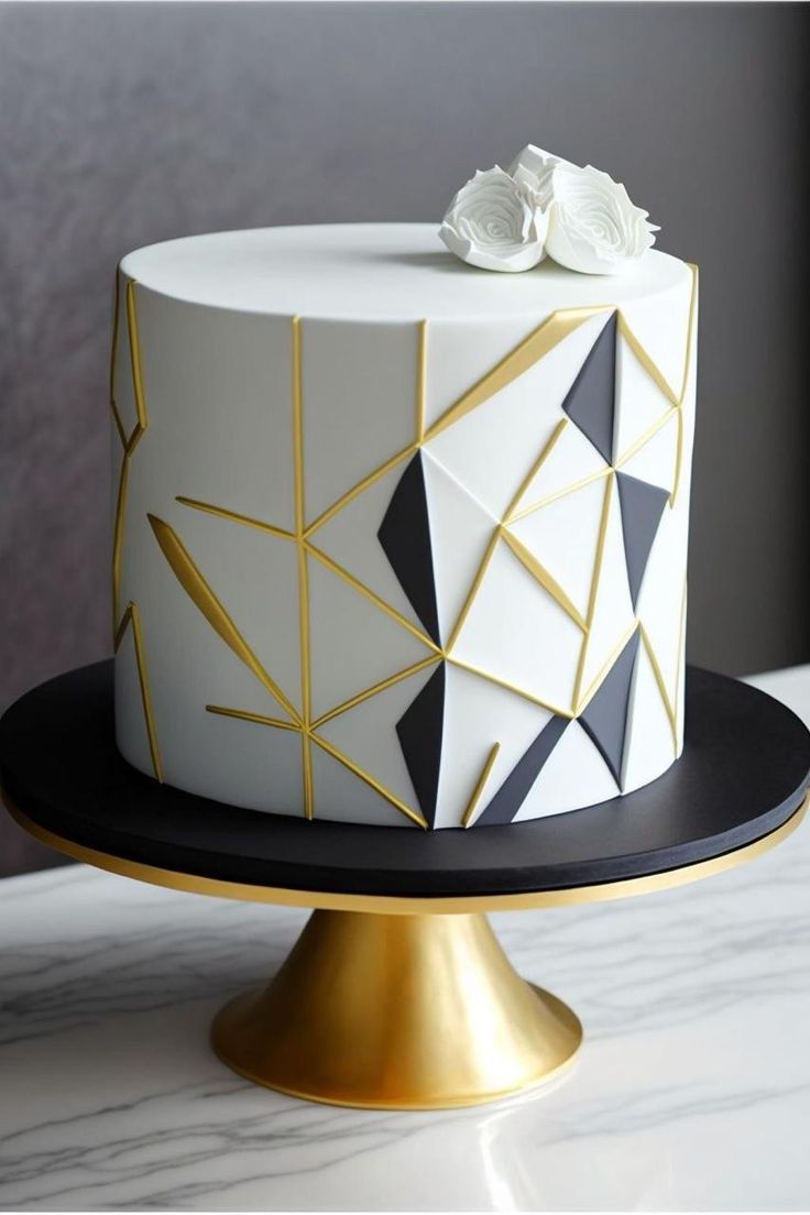 a white and black cake with gold accents