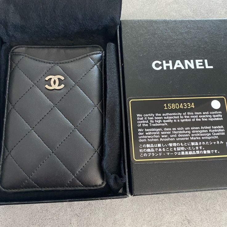 a chanel wallet is in its box and it's inside the case has a card slot