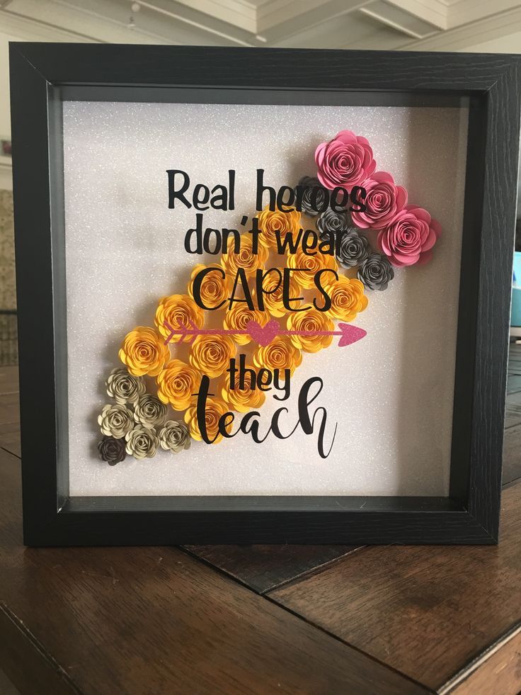 a shadow frame with some flowers in it and the words real houses don't wear capes they teach