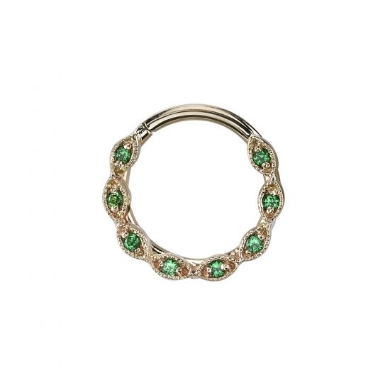 a gold ring with green stones in the middle and an open circle around it on a white background