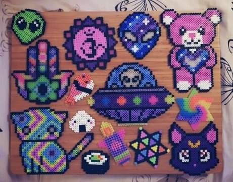 a wooden board topped with lots of cross stitch items