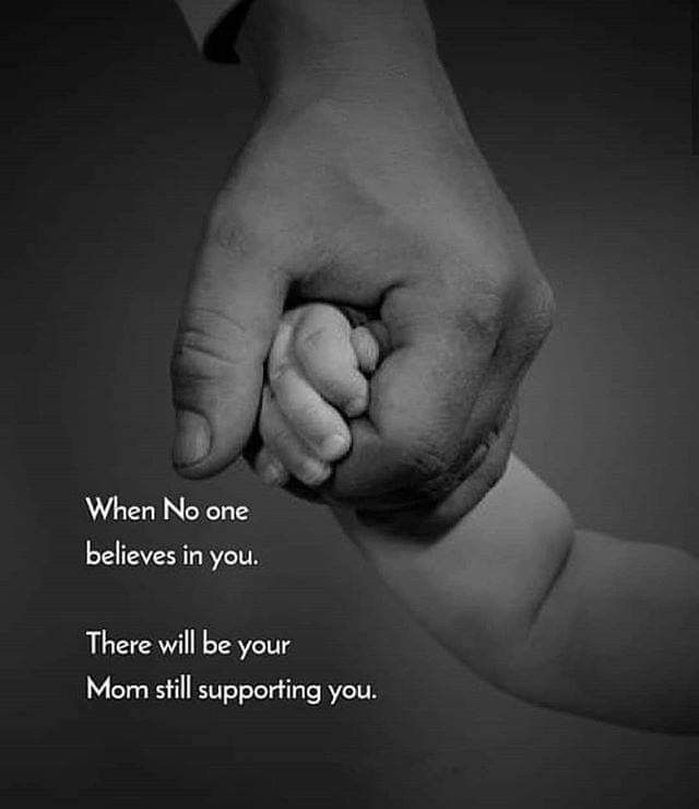 a black and white photo of a person holding a baby's hand with the words, when no one believe in you there will be your mom still supporting you