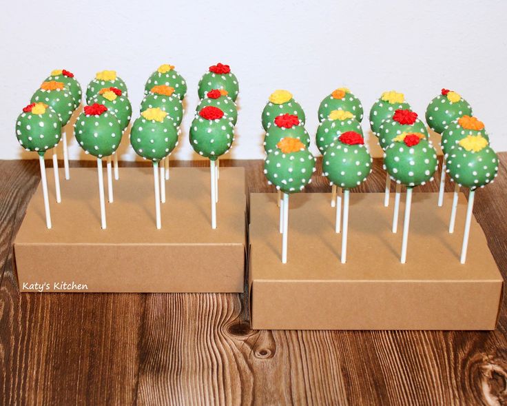 there are many green cactus lollipops on the sticks