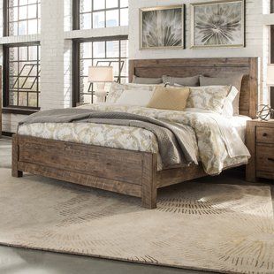 a bed sitting in a bedroom on top of a rug