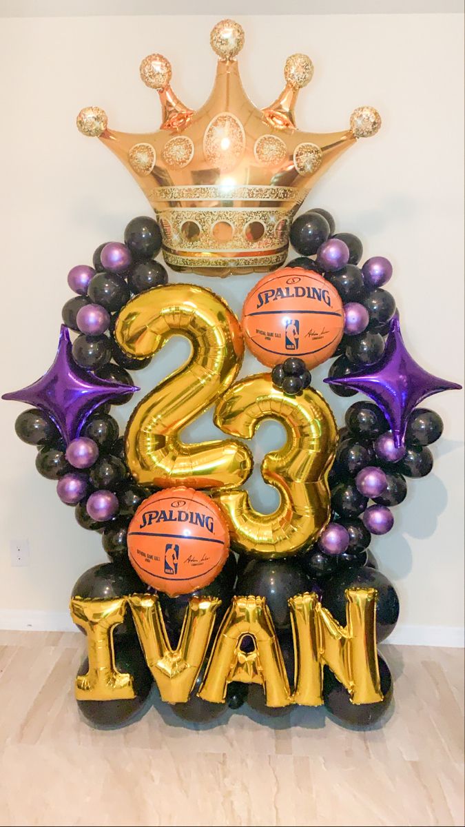 an image of a birthday decoration with balloons and basketballs on the top of it