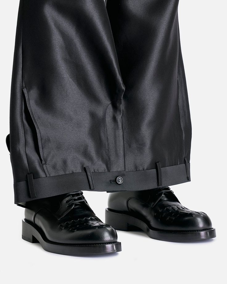 Comme des Garcons HOMME PLUS Upside Down Pants in Black. These pants feature a zip fly and button closure, four-pocket styling and functional zip fly and button waistband at the bottom hem. Comme Des Garcons Pants, Standard Cut Leg Pants For Workwear In Fall, Black Straight Leg Bottoms With Pressed Crease, Fall Straight Pants With Concealed Placket, Straight Pants With Concealed Placket For Fall, Black Bottoms With Button Zip Fly For Work, Black Button Zip Fly Bottoms For Work, Fall Workwear Bottoms With Standard Cut Leg, Fall Bottoms With Button Closure And Standard Cut Leg